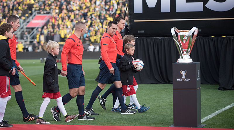 Jair Marrufo leads out his crew and the teams before the 2015 MLS Cup.