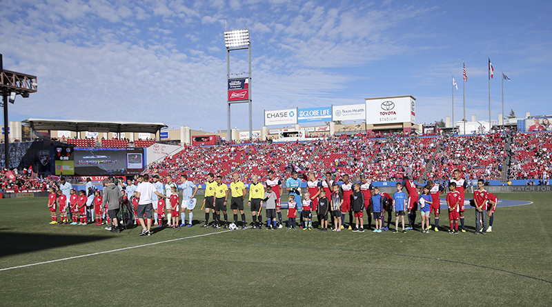 FC Dallas and Sporting Kansas City players stand for the national anthem before the match at Toyota Stadium.