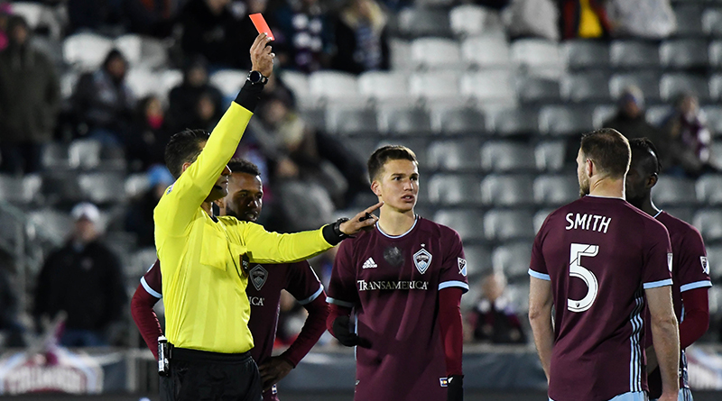 Colorado Rapids midfielder Cole Bassett (26) watches as defender Tommy Smith (5) is red carded by MLS referee Marcos DeOliveira during the second half against the Houston Dynamo.