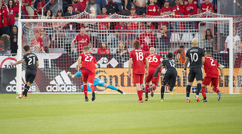 Sporting Kansas City midfielder Felipe Gutierrez (21) scores a goal against the Toronto FC on a penalty kick during the second half at BMO Field.