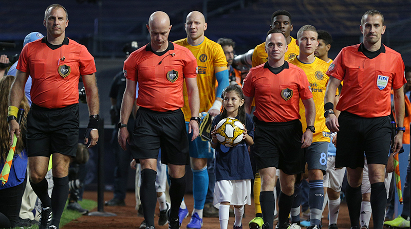 A young fan delivers the game ball with the officials before a game between the New York City FC and Atlanta United at Yankee Stadium.