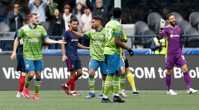 Seattle Sounders FC forward Jordan Morris (left) high fives midfielder Cristian Roldan (middle) after scoring the game winner goal against the Chicago Fire during the second half stoppage time at CenturyLink Field.