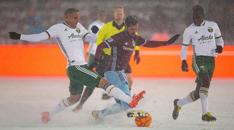 Colorado Rapids midfielder Benny Feilhaber (6) battles for the ball with Portland Timbers midfielder David Guzman (20) as midfielder Diego Chara (21) defends in the second half at Dick's Sporting Goods Park.
