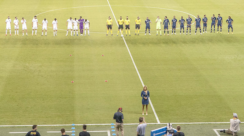 Chicago Fire and Sporting Kansas City players line up on the pitch during the singing of the national anthem before the first half at Children's Mercy Park.
